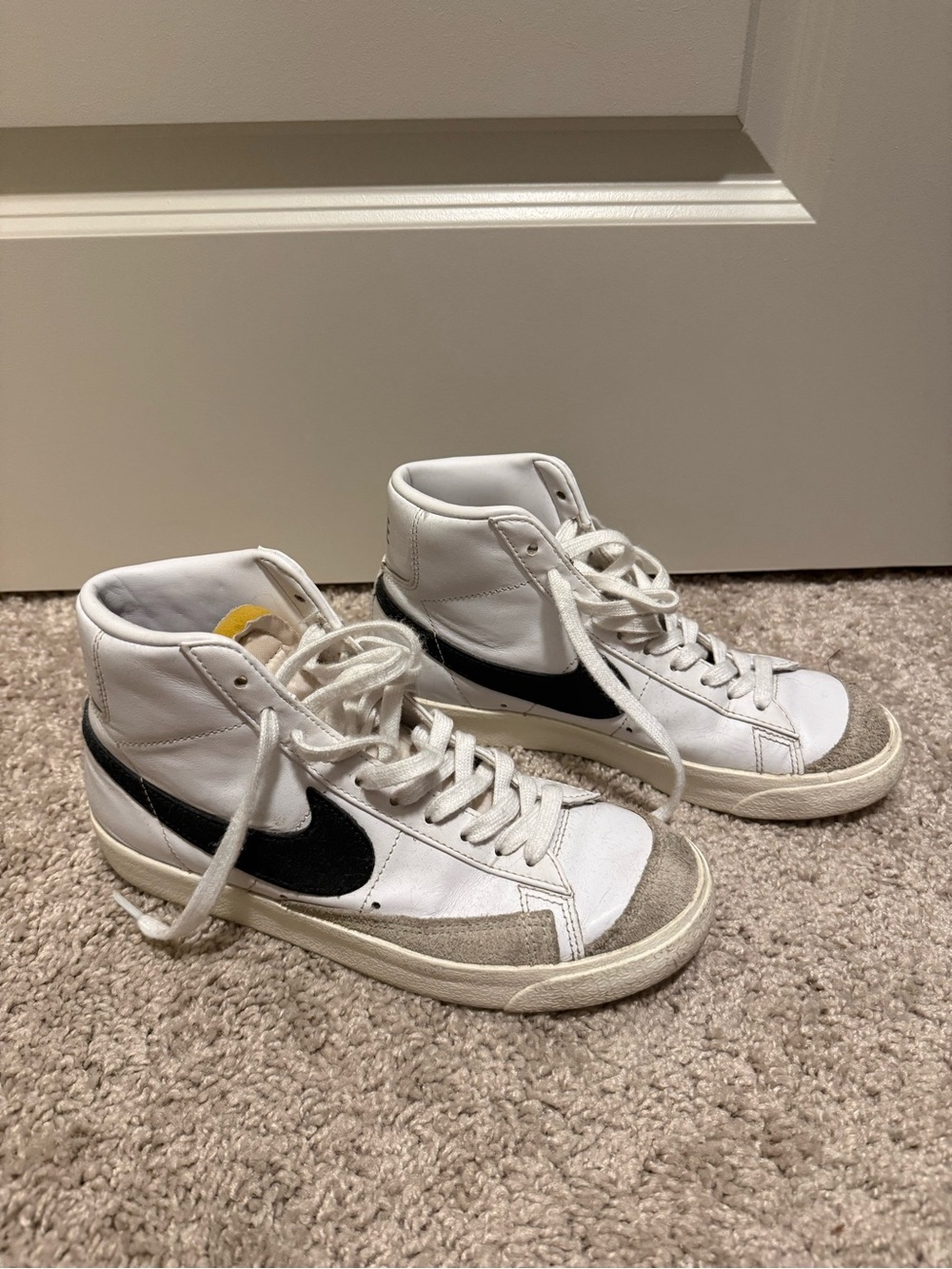 Nike White High-Top Sneakers with Black Swoosh